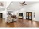 Open-concept living room with high ceilings, hardwood floors, and a view of the backyard pool at 7185 Ranchito Cir, Las Vegas, NV 89120