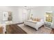 Bright main bedroom featuring a bed, night stands, and an attached bathroom at 7185 Ranchito Cir, Las Vegas, NV 89120
