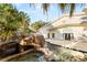 Inviting backyard pool featuring a rock waterfall and mature palm trees at 7185 Ranchito Cir, Las Vegas, NV 89120