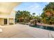 Beautiful backyard pool featuring mature palms, rock waterfall and ample patio space at 7185 Ranchito Cir, Las Vegas, NV 89120