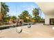 Inviting backyard pool featuring lush landscaping, rock waterfall feature and custom swing set at 7185 Ranchito Cir, Las Vegas, NV 89120