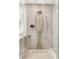Close up of a glass shower with light marble and rainfall shower head at 7185 Ranchito Cir, Las Vegas, NV 89120
