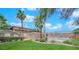 Community pool surrounded by grass and palm trees on a sunny day at 7300 Pirates Cove Rd # 2045, Las Vegas, NV 89145