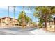 Condominium complex featuring lush landscaping and well-maintained buildings with palm trees against a clear blue sky at 7300 Pirates Cove Rd # 2045, Las Vegas, NV 89145