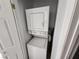 White stacked washer and dryer unit nestled in a closet at 7300 Pirates Cove Rd # 2045, Las Vegas, NV 89145