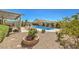 Spacious backyard showcasing a pool, patio, mature trees, and drought-tolerant landscaping at 7473 Crystal Clear Ave, Las Vegas, NV 89113
