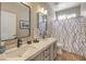 Bathroom featuring double sinks, tile floors, modern fixtures, and a shower/tub combo at 7473 Crystal Clear Ave, Las Vegas, NV 89113