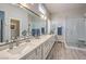 Bright bathroom boasts double sinks, quartz counters, and a walk-in shower at 7473 Crystal Clear Ave, Las Vegas, NV 89113