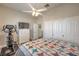 Comfortable bedroom showcasing a closet, dresser, TV, and a ceiling fan with lighting at 7473 Crystal Clear Ave, Las Vegas, NV 89113
