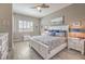 Serene bedroom with a white framed bed, shuttered windows, and a calming color palette at 7473 Crystal Clear Ave, Las Vegas, NV 89113