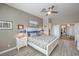 Comfortable bedroom with a king bed, a ceiling fan, and neutral paint at 7473 Crystal Clear Ave, Las Vegas, NV 89113
