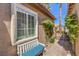 Charming exterior with a bench, window with shutters, and landscaped walkway to the front door at 7473 Crystal Clear Ave, Las Vegas, NV 89113