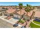 Stylish home boasts a three-car garage, manicured landscaping, and green lawns for curb appeal at 7473 Crystal Clear Ave, Las Vegas, NV 89113