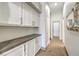 Hallway featuring white cabinets, drawers and stone countertops at 7473 Crystal Clear Ave, Las Vegas, NV 89113