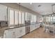 Contemporary kitchen with white cabinets, stainless steel appliances, and open layout to dining area at 7473 Crystal Clear Ave, Las Vegas, NV 89113