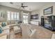Inviting living room with tile floors, cozy seating, and sliding glass doors to the outdoor space at 7473 Crystal Clear Ave, Las Vegas, NV 89113
