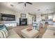 Spacious living room flowing into the kitchen and dining area, featuring a fireplace and entertainment center at 7473 Crystal Clear Ave, Las Vegas, NV 89113