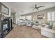 Open-concept living area with fireplace, dining space, and comfortable seating arrangement at 7473 Crystal Clear Ave, Las Vegas, NV 89113