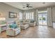 Cozy living room with a plush sectional, tile flooring, and a view of the pool at 7473 Crystal Clear Ave, Las Vegas, NV 89113