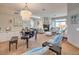 Spacious living room with a fireplace, chandelier, and tile flooring throughout at 7473 Crystal Clear Ave, Las Vegas, NV 89113