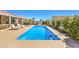 A refreshing pool surrounded by a concrete deck and desert landscaping, perfect for outdoor enjoyment at 7473 Crystal Clear Ave, Las Vegas, NV 89113