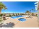 An inviting pool and spa surrounded by desert landscaping and ample space for lounging at 7473 Crystal Clear Ave, Las Vegas, NV 89113