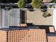 Aerial view showcasing the backyard with a covered patio, desert landscaping, and terracotta tile roof at 7825 Desert Bell Ave, Las Vegas, NV 89128