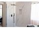 Modern bathroom featuring an open glass shower with square rain shower head and marble-look tile surround at 7825 Desert Bell Ave, Las Vegas, NV 89128