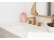 Modern bathroom sink features a gold faucet, white countertop, and a decorative mirror at 7825 Desert Bell Ave, Las Vegas, NV 89128