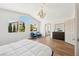 Spacious bedroom with high ceilings, large windows, modern furniture and decor at 7825 Desert Bell Ave, Las Vegas, NV 89128