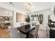 Contemporary dining room with modern chandelier and backyard views at 7825 Desert Bell Ave, Las Vegas, NV 89128