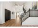 Bright foyer with high ceilings, modern light fixture and staircase at 7825 Desert Bell Ave, Las Vegas, NV 89128