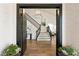 Home entry featuring double doors, a staircase, and modern light fixture at 7825 Desert Bell Ave, Las Vegas, NV 89128