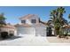 Two-story home featuring a tile roof, three-car garage, and desert landscaping at 7825 Desert Bell Ave, Las Vegas, NV 89128