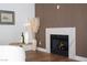 Modern fireplace with marble surround and decorative accents on wooden floor at 7825 Desert Bell Ave, Las Vegas, NV 89128