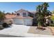 Charming two-story home with a three-car garage, desert landscaping, and a well-manicured front yard at 7825 Desert Bell Ave, Las Vegas, NV 89128
