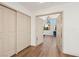 Hallway with closet, wooden floors, and an open doorway into the bedroom at 7825 Desert Bell Ave, Las Vegas, NV 89128