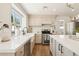 Bright kitchen featuring a farmhouse sink, white countertops, and stainless steel appliances at 7825 Desert Bell Ave, Las Vegas, NV 89128