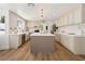 Bright open kitchen with modern island, white countertops, and stainless steel appliances at 7825 Desert Bell Ave, Las Vegas, NV 89128