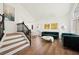 Open living area featuring a staircase, and modern furnishings at 7825 Desert Bell Ave, Las Vegas, NV 89128