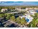Aerial view of commercial buildings, lush landscaping, and parking, with mountain views at 8052 Marbella Cir, Las Vegas, NV 89128