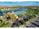 Aerial view of community pool, lush landscaping, parking, and lake with city skyline in background at 8052 Marbella Cir, Las Vegas, NV 89128