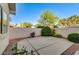 A private backyard featuring mature landscaping and a concrete patio, perfect for outdoor enjoyment at 8052 Marbella Cir, Las Vegas, NV 89128