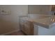 Wet bar area showcases tile countertops and ample storage cabinets for entertaining guests and functionality at 8052 Marbella Cir, Las Vegas, NV 89128
