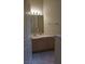 Half bathroom with vanity, tiled floors, and well-lit mirror at 8052 Marbella Cir, Las Vegas, NV 89128