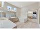 Bathroom featuring double sinks, a bathtub, tiled floors, a large mirror, and vanity with drawers at 8052 Marbella Cir, Las Vegas, NV 89128