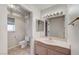 Bathroom features vanity with sink, toilet and a big mirror at 8052 Marbella Cir, Las Vegas, NV 89128