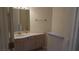 Neutral bathroom featuring a single sink vanity and warm neutral wall color at 8052 Marbella Cir, Las Vegas, NV 89128