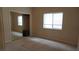 Bedroom featuring a closet, plush carpeting, and window with natural light at 8052 Marbella Cir, Las Vegas, NV 89128
