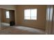Bedroom featuring a closet, neutral carpeting, and a large window at 8052 Marbella Cir, Las Vegas, NV 89128